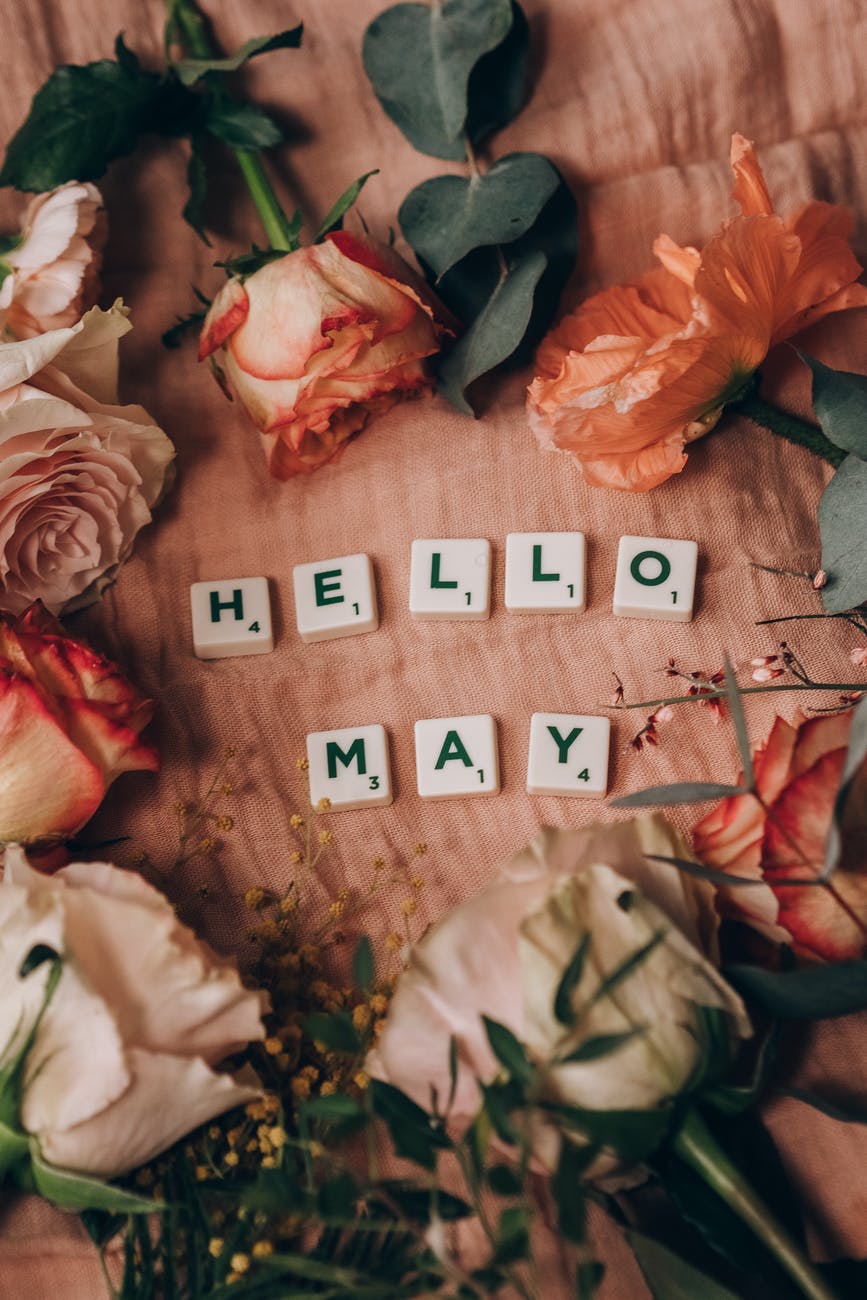 scrabble tiles surrounded by beautiful flowers